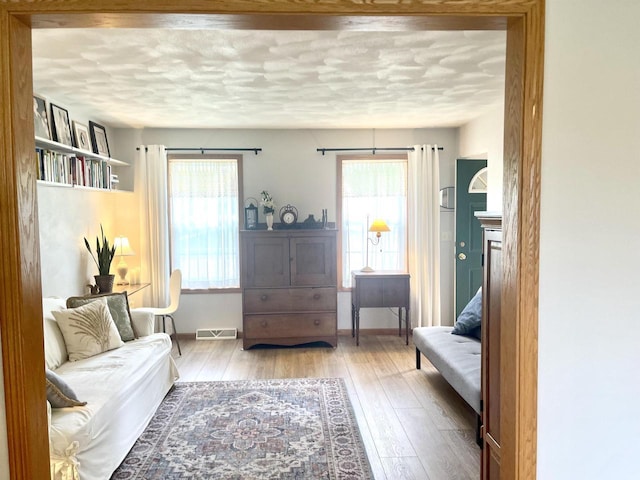 1401 E Bedford Ln, Appleton, WI 54915 - sitting room with healthy amount of natural light, hardwood / wood-style flooring, a textured ceiling, and baseboards