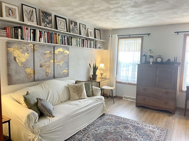 1401 E Bedford Ln, Appleton, WI 54915 - living area with wood finished floors, baseboards, and a textured ceiling