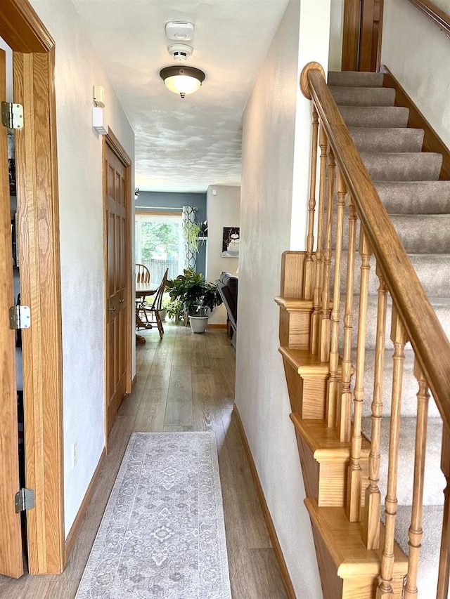 1401 E Bedford Ln, Appleton, WI 54915 - corridor featuring wood finished floors, stairway, and baseboards