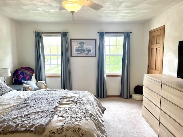 1401 E Bedford Ln, Appleton, WI 54915 - bedroom featuring light carpet, multiple windows, ceiling fan, and baseboards