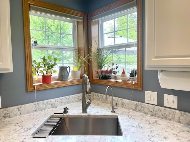 1401 E Bedford Ln, Appleton, WI 54915 - kitchen view of a sink, light stone countertops, and white cabinetry