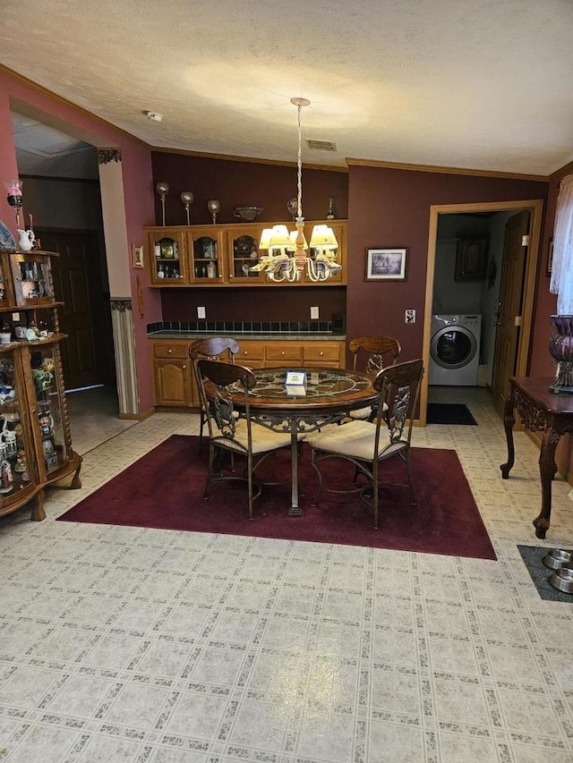 7098 Fire Tower Rd, Rhinelander, WI 54501 - dining room with washer / dryer, a chandelier, and light flooring