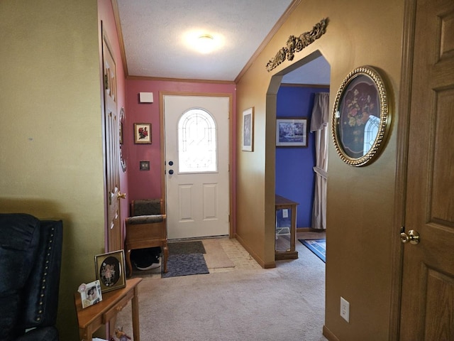 7098 Fire Tower Rd, Rhinelander, WI 54501 - entrance foyer featuring light carpet, crown molding, arched walkways, and a textured ceiling
