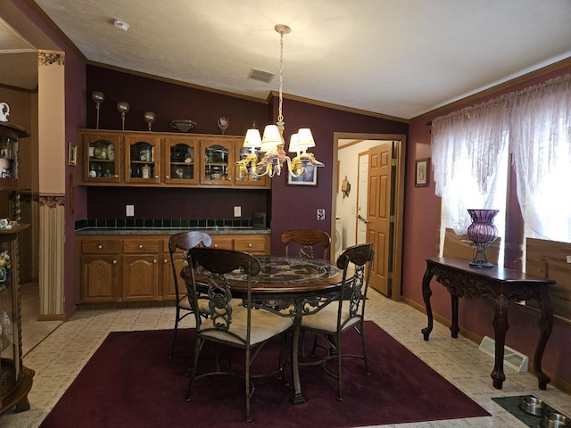 7098 Fire Tower Rd, Rhinelander, WI 54501 - dining area with ornamental molding, light flooring, lofted ceiling, and a chandelier