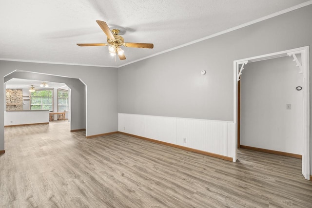 8401 4th Ave, Almond, WI 54909 - unfurnished room with wood finished floors, ceiling fan, arched walkways, crown molding, and a textured ceiling