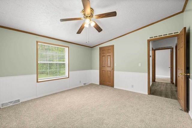 8401 4th Ave, Almond, WI 54909 - carpeted spare room with wainscoting, a textured ceiling, a ceiling fan, vaulted ceiling, and crown molding