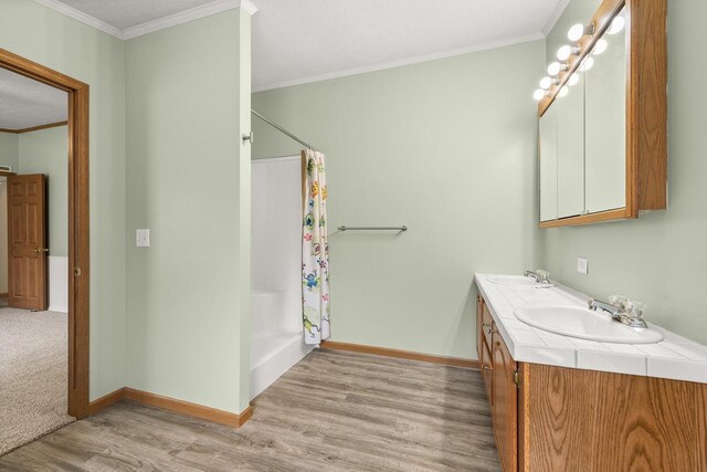 8401 4th Ave, Almond, WI 54909 - full bath with wood finished floors, double vanity, baseboards, ornamental molding, and curtained shower