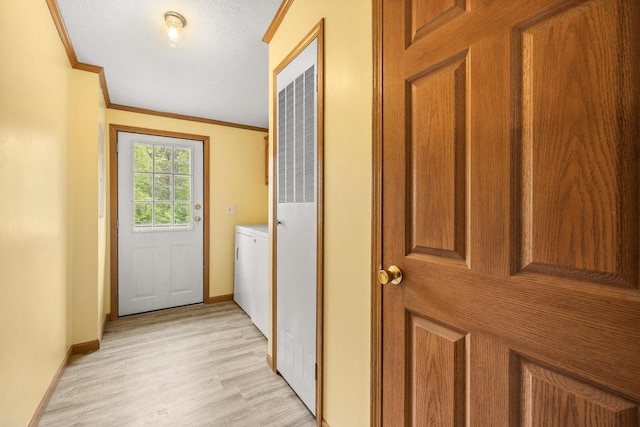 8401 4th Ave, Almond, WI 54909 - laundry room with crown molding, baseboards, light wood finished floors, and washer and clothes dryer