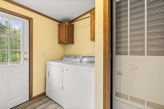 8401 4th Ave, Almond, WI 54909 - laundry area featuring a heating unit, cabinet space, light wood-style floors, washer and dryer, and healthy amount of natural light