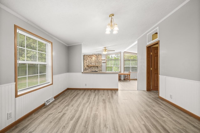 8401 4th Ave, Almond, WI 54909 - unfurnished room with a chandelier, wood finished floors, wainscoting, a ceiling fan, and ornamental molding