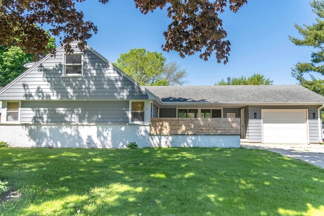 1230 Hiawatha Dr, Beaver Dam, WI 53916 - view of front of house featuring a garage, a front lawn, brick siding, and concrete driveway