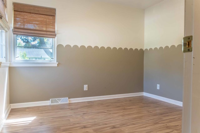 1230 Hiawatha Dr, Beaver Dam, WI 53916 - spare room featuring light wood-style flooring and baseboards