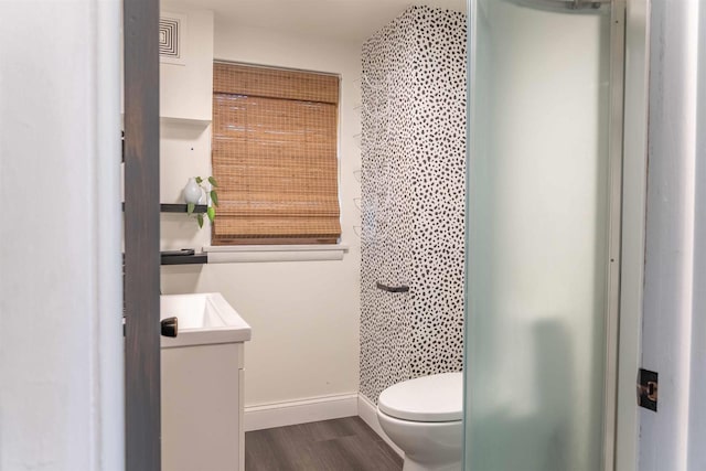 1230 Hiawatha Dr, Beaver Dam, WI 53916 - bathroom featuring vanity, wood finished floors, toilet, and baseboards