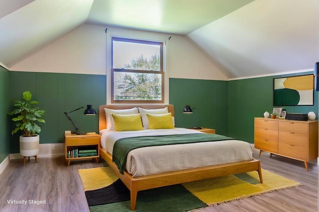 1230 Hiawatha Dr, Beaver Dam, WI 53916 - bedroom featuring wood finished floors and vaulted ceiling