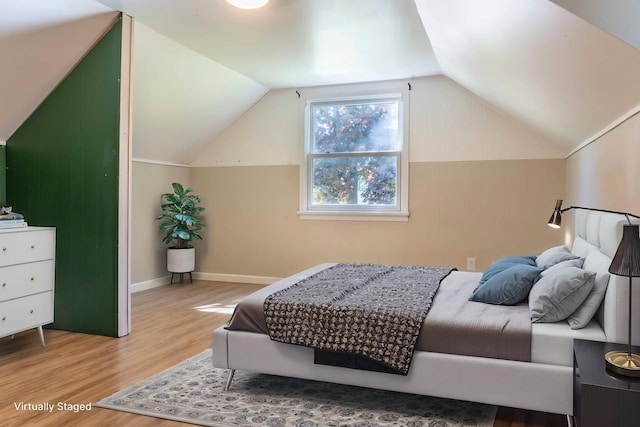 1230 Hiawatha Dr, Beaver Dam, WI 53916 - bedroom featuring wood finished floors, lofted ceiling, and baseboards
