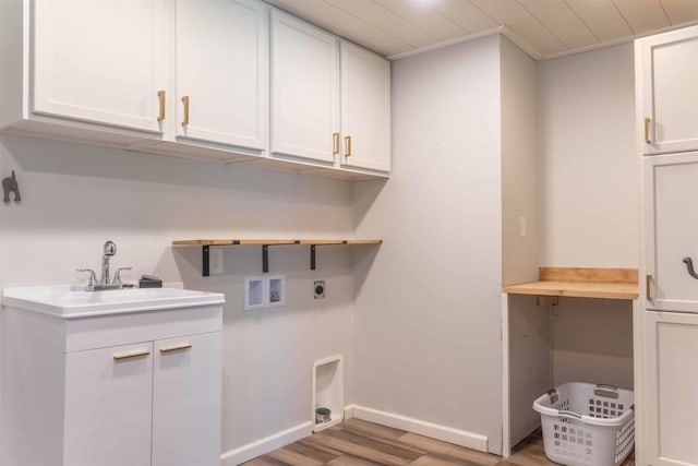 1230 Hiawatha Dr, Beaver Dam, WI 53916 - laundry room featuring hookup for an electric dryer, washer hookup, cabinet space, light wood-style floors, and baseboards