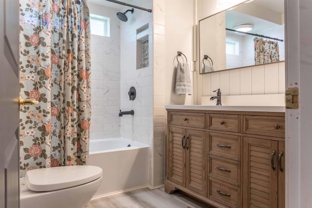 1230 Hiawatha Dr, Beaver Dam, WI 53916 - bathroom featuring vanity, toilet, shower / bath combination with curtain, and wood finished floors