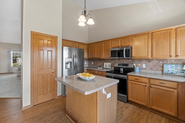 1758 Raintree Ln Unit 45, Mount Pleasant, WI 53406 - kitchen featuring appliances with stainless steel finishes, a chandelier, light countertops, decorative backsplash, and light wood-type flooring