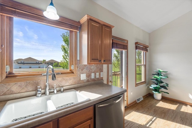 1758 Raintree Ln Unit 45, Mount Pleasant, WI 53406 - kitchen featuring dishwasher, a sink, backsplash, wood finished floors, and vaulted ceiling