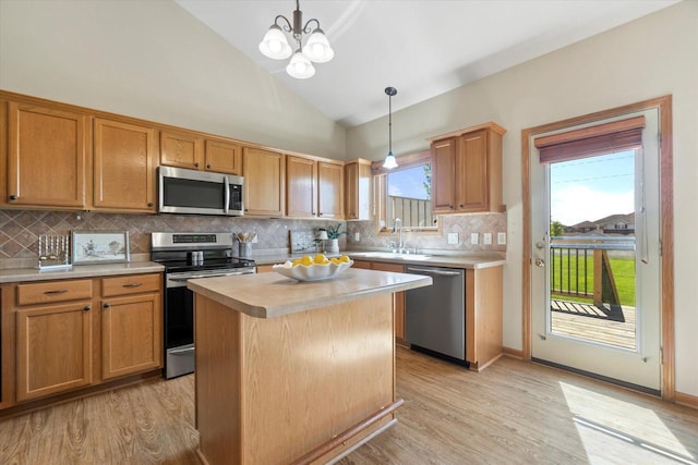 1758 Raintree Ln Unit 45, Mount Pleasant, WI 53406 - kitchen with stainless steel appliances, a sink, light countertops, lofted ceiling, and light wood-style floors