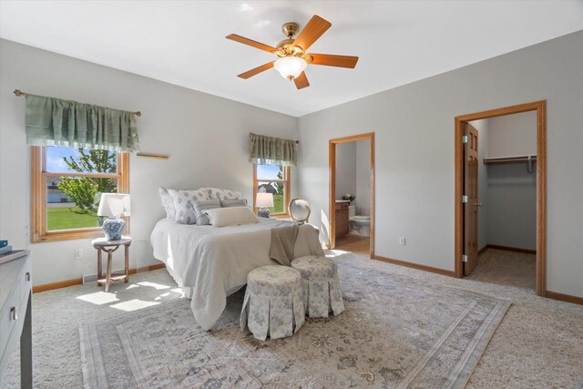 1758 Raintree Ln Unit 45, Mount Pleasant, WI 53406 - carpeted bedroom featuring baseboards, ensuite bath, a ceiling fan, and a spacious closet