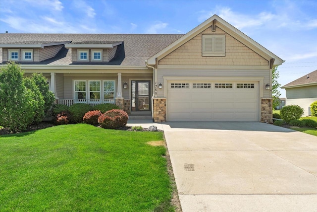 1758 Raintree Ln Unit 45, Mount Pleasant, WI 53406 - craftsman house with stone siding, a front yard, driveway, a garage, and a porch