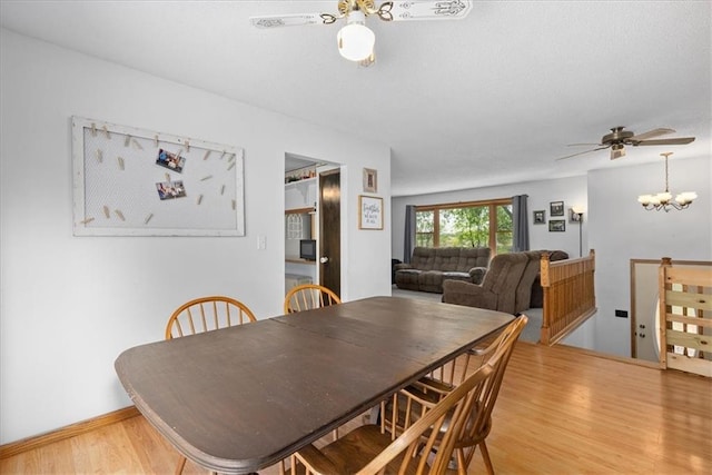 E7065 E County Road B, Colfax, WI 54730 - dining room with light wood finished floors, ceiling fan, and a chandelier