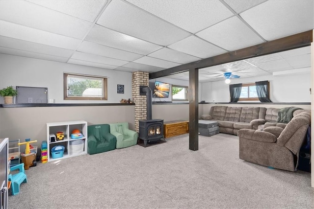 E7065 E County Road B, Colfax, WI 54730 - living room with a wood stove, carpet, and a paneled ceiling