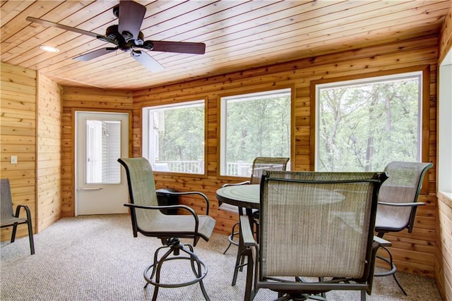 4708 Abbey Rd, Eau Claire, WI 54701 - dining space with healthy amount of natural light, wood walls, ceiling fan, wood ceiling, and carpet floors