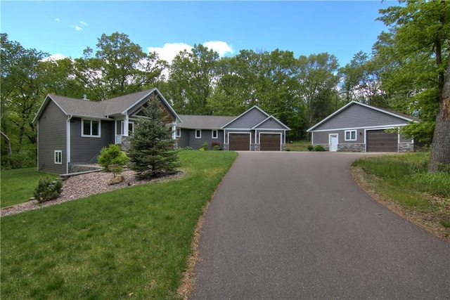 4708 Abbey Rd, Eau Claire, WI 54701 - ranch-style home with an attached garage, a front lawn, driveway, and view of scattered trees