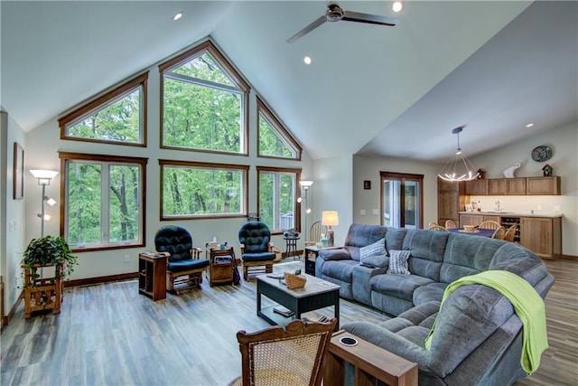 4708 Abbey Rd, Eau Claire, WI 54701 - living room featuring healthy amount of natural light, light wood-style flooring, baseboards, a ceiling fan, and high vaulted ceiling