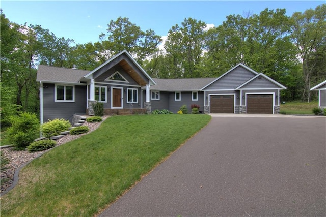 4708 Abbey Rd, Eau Claire, WI 54701 - craftsman inspired home with a garage, a front yard, stone siding, and driveway