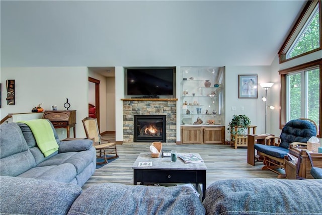 4708 Abbey Rd, Eau Claire, WI 54701 - living area featuring vaulted ceiling, a fireplace, and light wood finished floors
