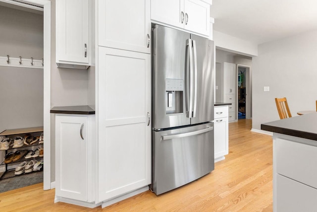 208 Edgewood Dr, Neenah, WI 54956 - kitchen with stainless steel fridge with ice dispenser, dark countertops, light wood-style floors, and white cabinets
