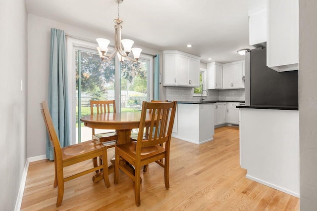 208 Edgewood Dr, Neenah, WI 54956 - dining room with a chandelier, light wood-type flooring, baseboards, and recessed lighting