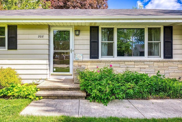 208 Edgewood Dr, Neenah, WI 54956 - doorway to property featuring stone siding and covered porch