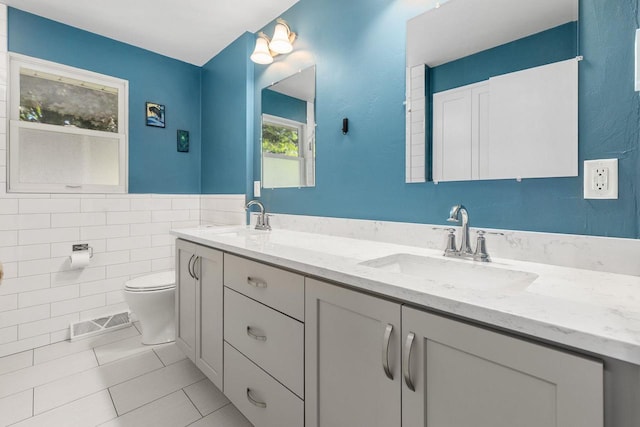 208 Edgewood Dr, Neenah, WI 54956 - bathroom with double vanity, toilet, tile patterned flooring, and tile walls