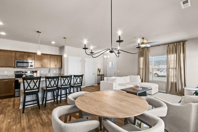 4857 Suelo Rd, Fitchburg, WI 53711 - dining area featuring a chandelier, dark wood-type flooring, and recessed lighting