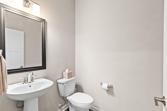 4857 Suelo Rd, Fitchburg, WI 53711 - half bathroom with toilet, baseboards, and a sink