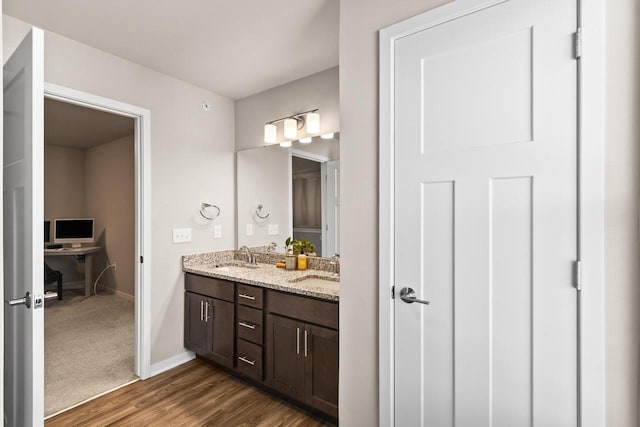 4857 Suelo Rd, Fitchburg, WI 53711 - full bath featuring double vanity, wood finished floors, and baseboards