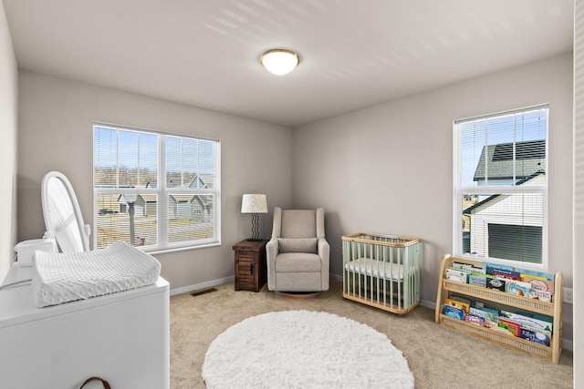 4857 Suelo Rd, Fitchburg, WI 53711 - carpeted bedroom featuring multiple windows, baseboards, and a nursery area