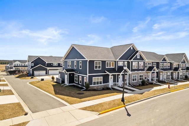 4857 Suelo Rd, Fitchburg, WI 53711 - view of property with a residential view, stone siding, driveway, and a garage
