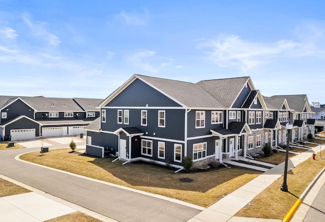 4857 Suelo Rd, Fitchburg, WI 53711 - view of front of home with a residential view, a front yard, and a garage