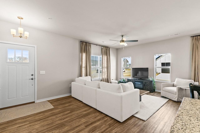 4857 Suelo Rd, Fitchburg, WI 53711 - living room with wood finished floors, a chandelier, a ceiling fan, and baseboards