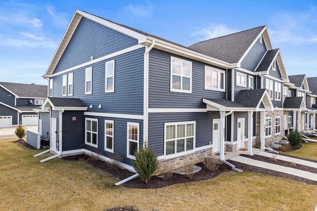 4857 Suelo Rd, Fitchburg, WI 53711 - view of side of property with a yard, stone siding, and a shingled roof