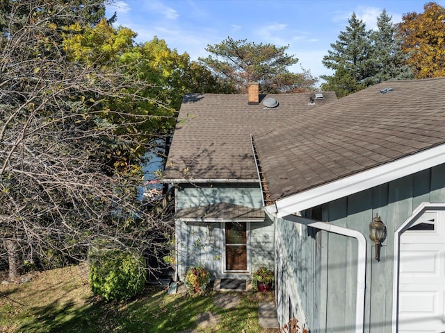 N53W34956 Rd B, Okauchee, WI 53069 - back of house with a shingled roof and a chimney