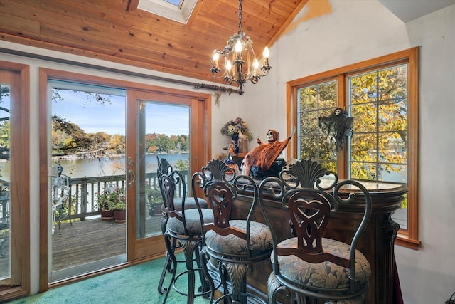 N53W34956 Rd B, Okauchee, WI 53069 - carpeted dining space with wood ceiling, a skylight, a chandelier, vaulted ceiling, and a water view