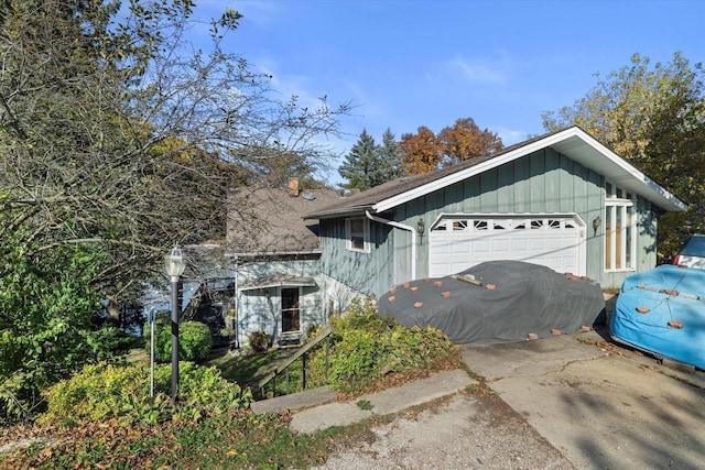N53W34956 Rd B, Okauchee, WI 53069 - view of side of property with board and batten siding and a garage