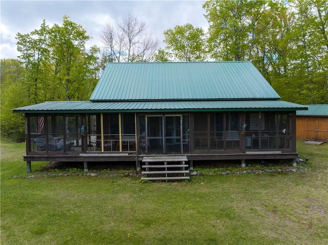 82912 Augustine Rd, Glidden, WI 54527 - back of house with a sunroom, a lawn, and metal roof