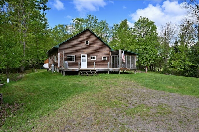 82912 Augustine Rd, Glidden, WI 54527 - back of property featuring faux log siding, a sunroom, a wooden deck, and a lawn